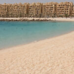 Travel planning visual for What must an Al Marjan Island resale buyer verify before signing an offer